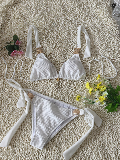 Shelly Beach white bikini flat lay with gold shell hardware detail